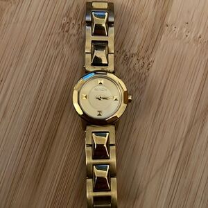 Slim gold Nixon watch - stud details